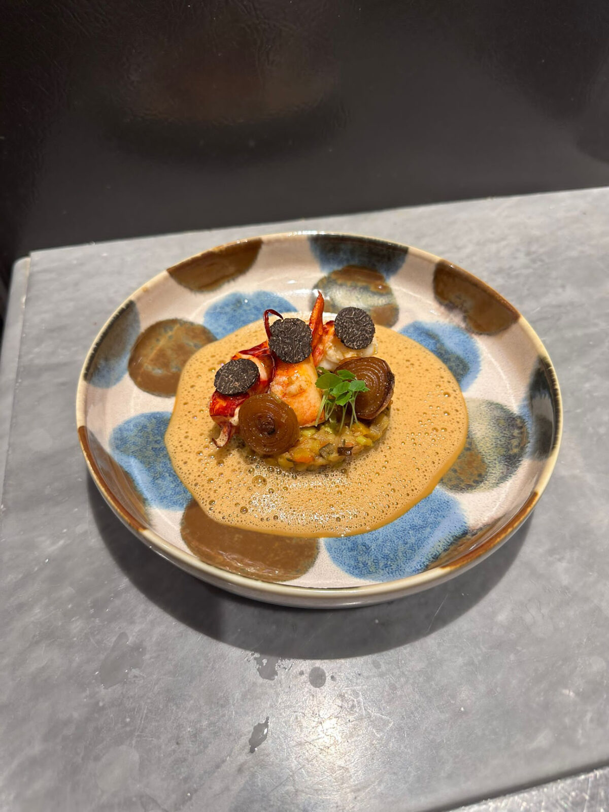 Lobster with truffle and a light bisque in a hand-painted bowl